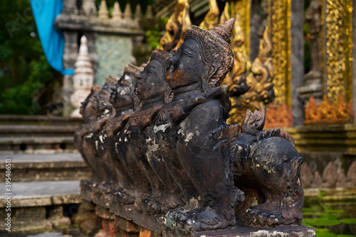 traditional temple architecture on koh samui in thailand  southeast asian culture  welcoming statue at the entrance