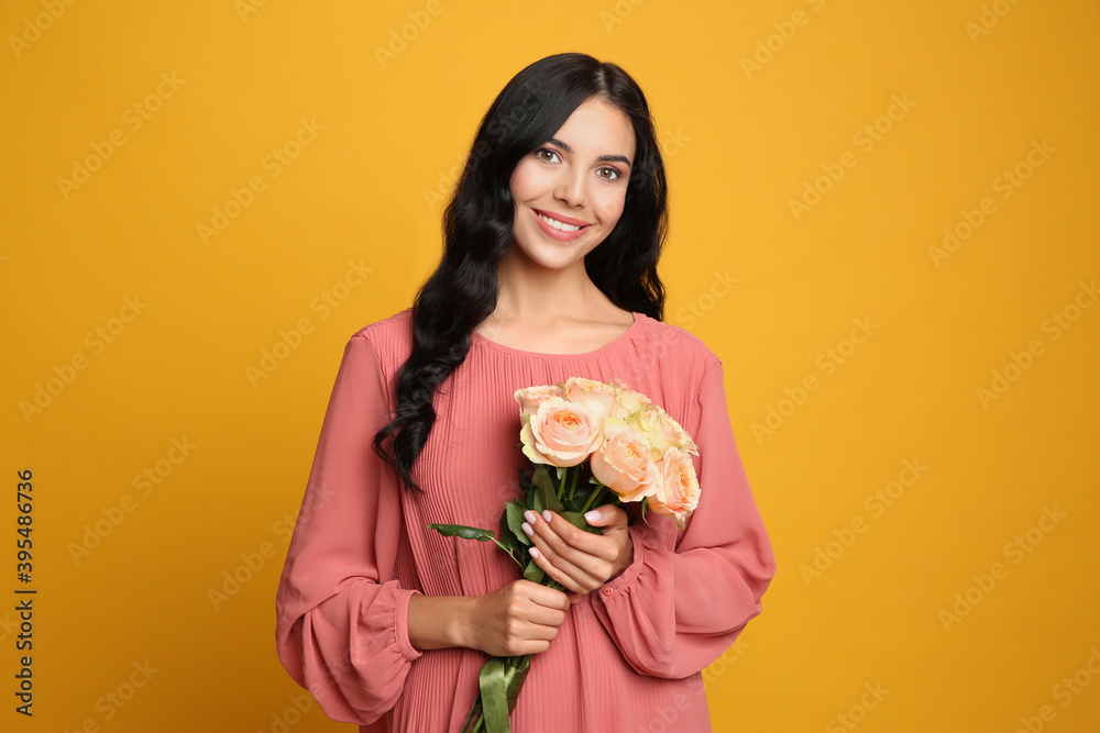 Portrait of smiling woman with beautiful bouquet on orange background Portrait of smiling woman with beautiful bouquet on orange background