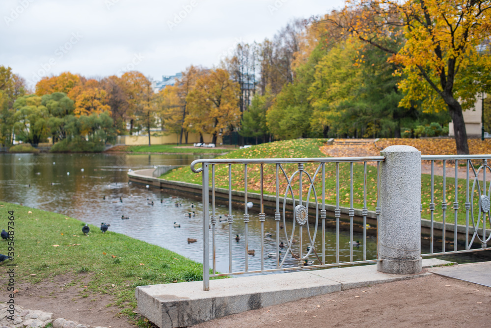 grey bridge on the river in the autumn city park grey bridge on the river in the autumn city park