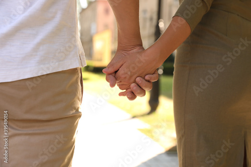 Couple walking in park on summer day, closeup