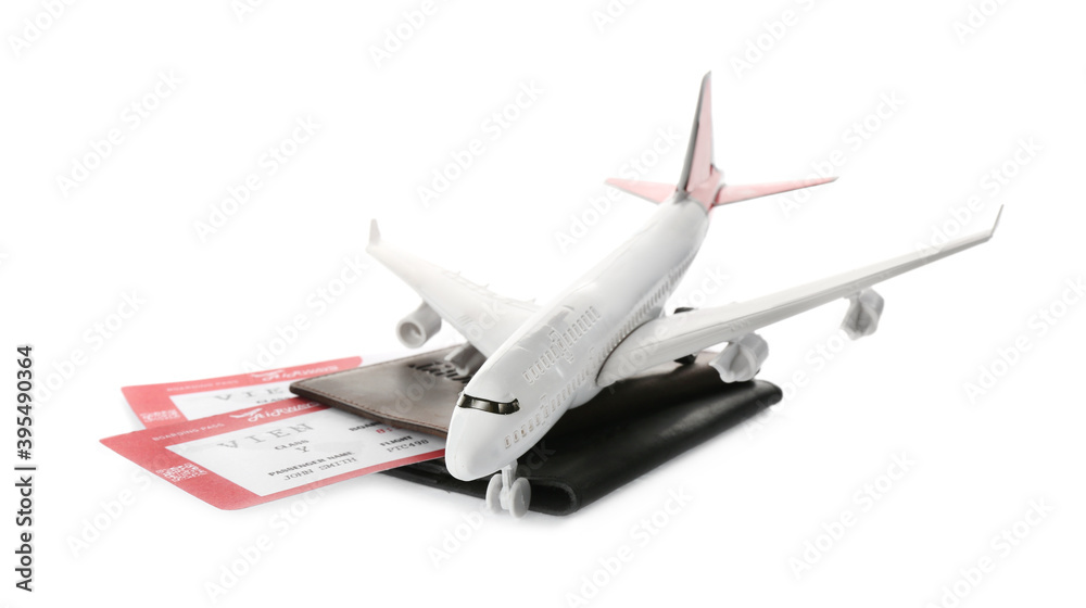 Toy airplane and passport with tickets on white background Toy airplane and passport with tickets on white background