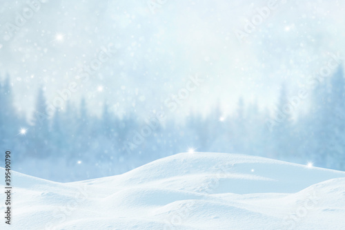 Winter Xmas background with snowfall and blurred bokeh.Merry Christmas and happy New Year greeting card with copy-space. Christmas landscape with snow covered fir trees in forest