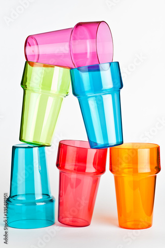 Colorful plastic glasses on top each other.