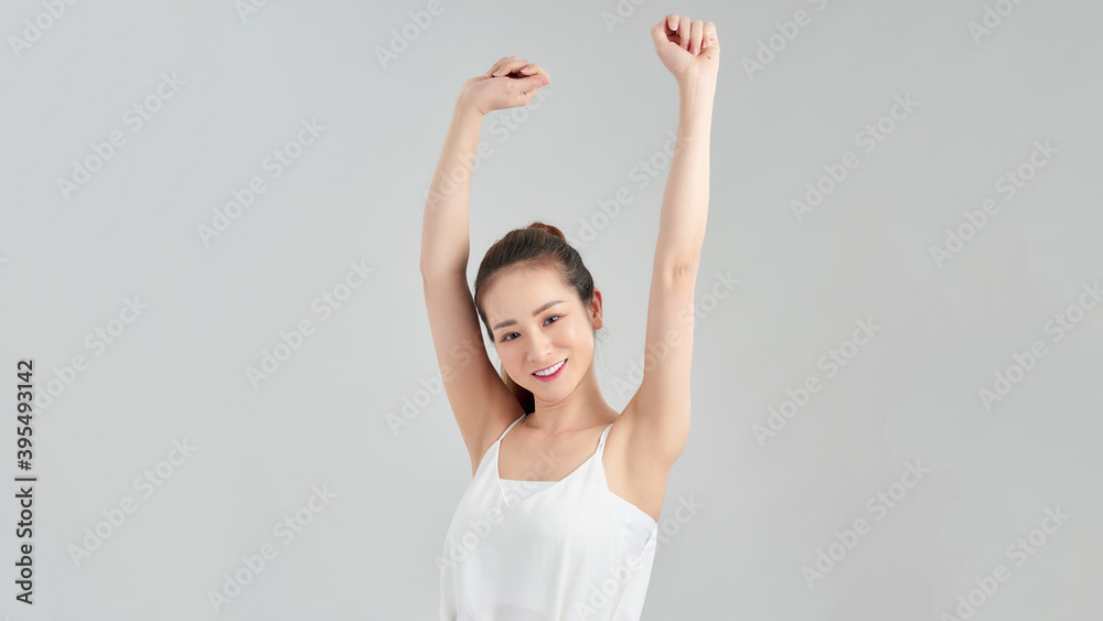 Beautiful girl gesturing triumphal fists puts her hands up, isolated on white background