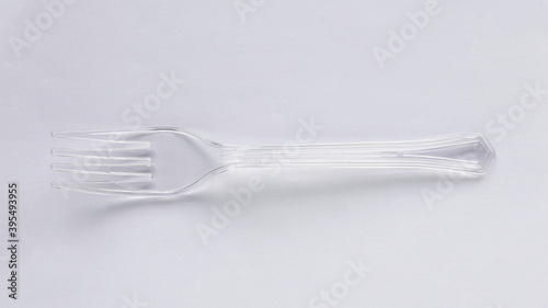 A plastic disposable transparent fork isolated on white background.