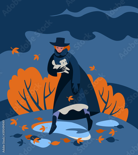 Against background of an autumn landscape with dark clouds and yellow trees leaves, a woman in a black coat and hat with a white dog steps over puddles