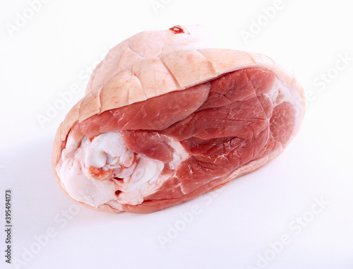 Raw rear pork leg with cut skin, ready for roasting