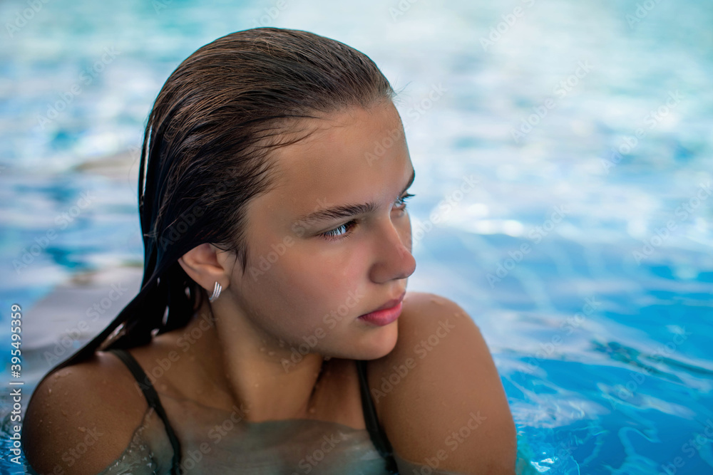 Fashion close up portrait of graceful cute girl posing in the pool during holidays on luxury resort. Cheerful plus size teenage girl enjoying. happy, positive emotion, summer style. Fashion close up portrait of graceful cute girl posing in the pool during holidays on luxury resort. Cheerful plus size teenage girl enjoying. happy, positive emotion, summer style.