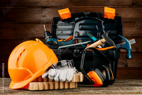 Obraz na plátně Open plastic tool kit box with construction safety helmet and various hand tools