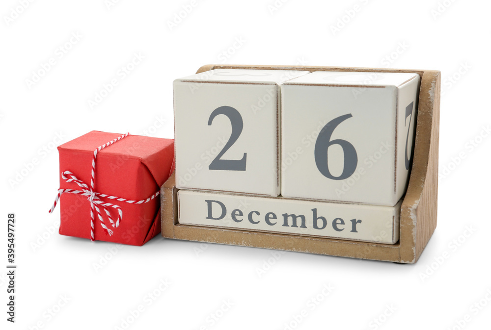 Wooden block calendar with date 26th of December near gift on white background. Boxing day Wooden block calendar with date 26th of December near gift on white background. Boxing day