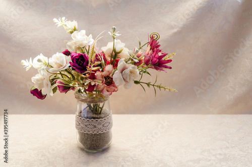 Close-up of a gentle floral composition in a vase on the light background