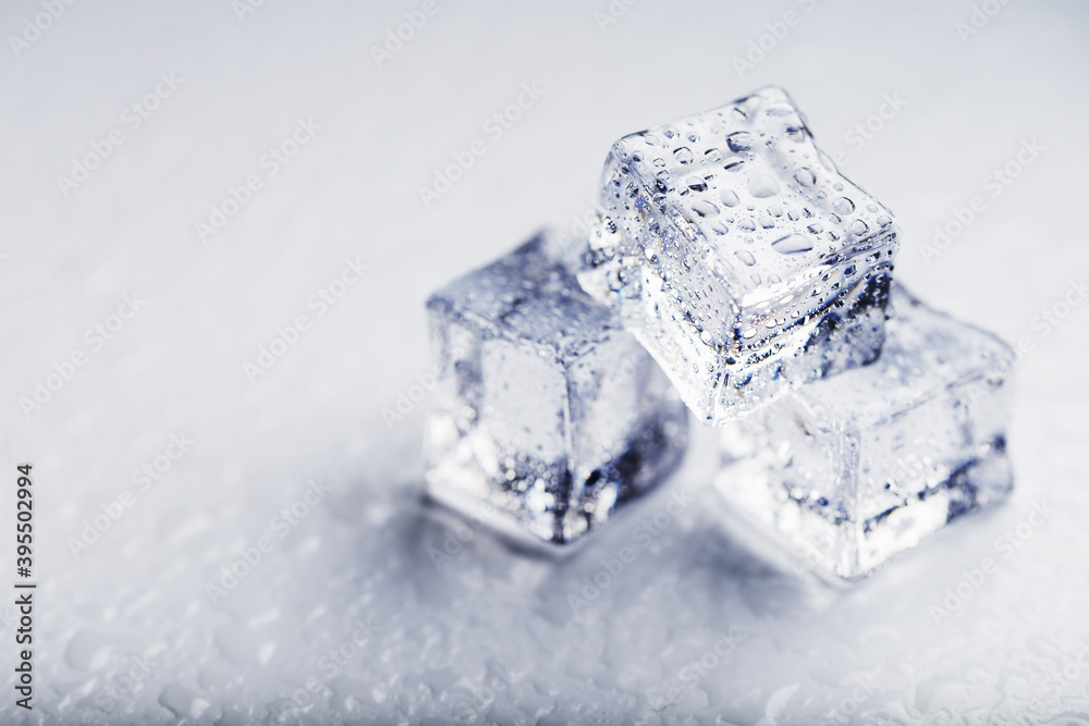 Ice with meltwater drops close-up on a white background. Ice with meltwater drops close-up on a white background.