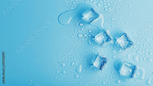 Wallpaper Mural Ice cubes with drops of melt water water on a blue background, top view. Torontodigital.ca