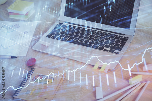 Stock market graph and table with computer background. Multi exposure. Concept of financial analysis.