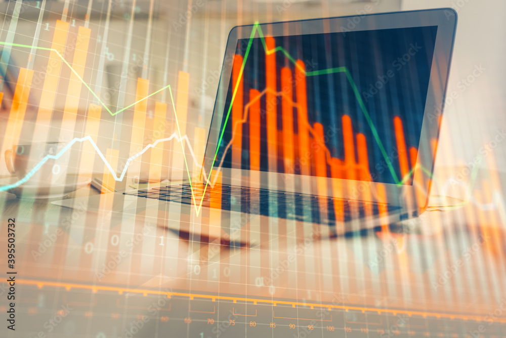 Forex Chart hologram on table with computer background. Double exposure. Concept of financial markets. Forex Chart hologram on table with computer background. Double exposure. Concept of financial markets.