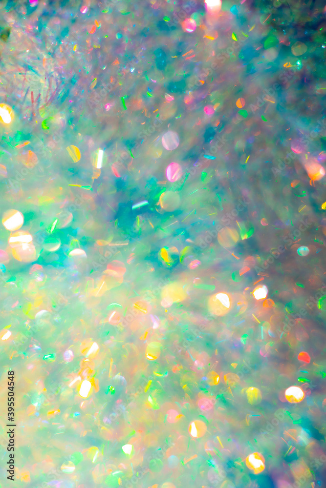 Christmas festive background. Multicolored glowing bokeh from tinsel, place for text