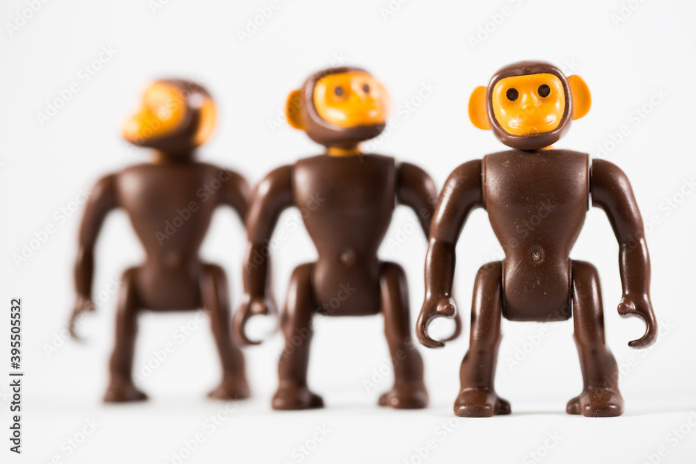 Three toy monkeys distanced from each other Three toy monkeys distanced from each other