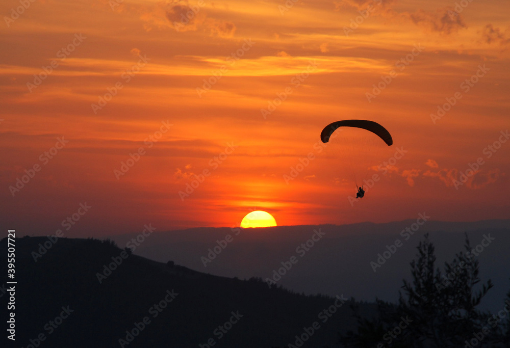 paragliding into the sun