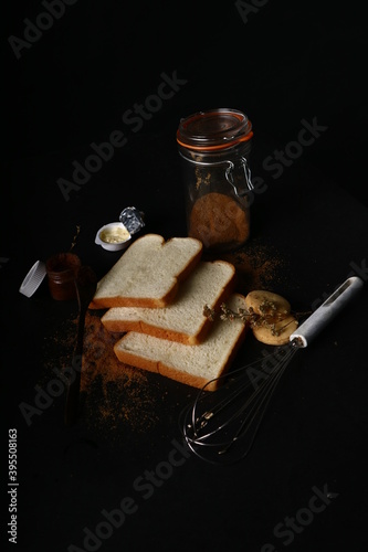 food photography bread butter jam on black background