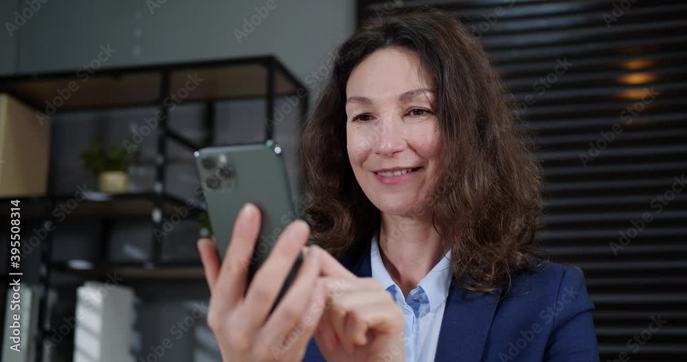 Mykolaiv, Ukraine - November 16, 2020: Businesswoman using modern phone in office