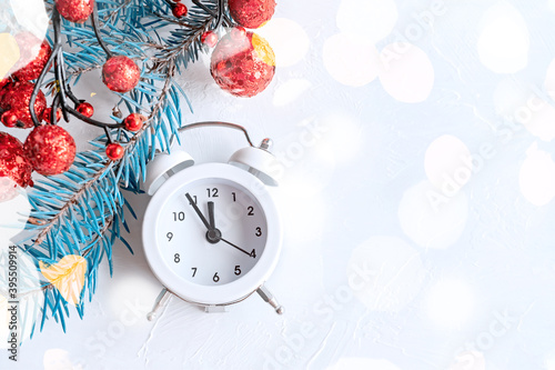 Christmas background with clock on light background. New year at midnight-old clock on the background of bokeh holiday lights and fireworks