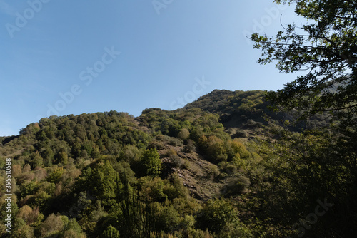 Formigueiros peak Courel hillside with autumn sunlight and blue sky photo