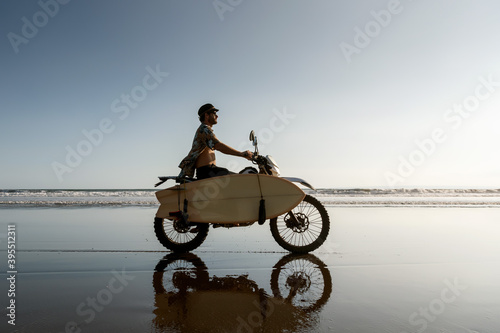 Photography Real balinese surfer with motorcycle and surfboard