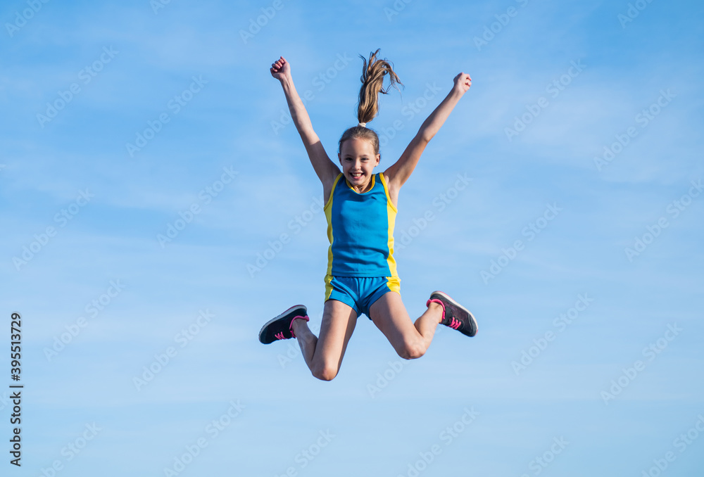 happy kid in sport training clothes jumping outdoor, happiness
