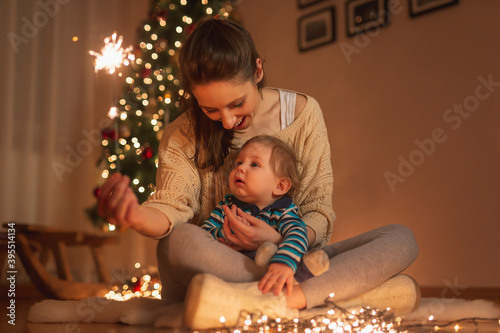 Photography Mother and son holding a sparkler for New Year's Eve