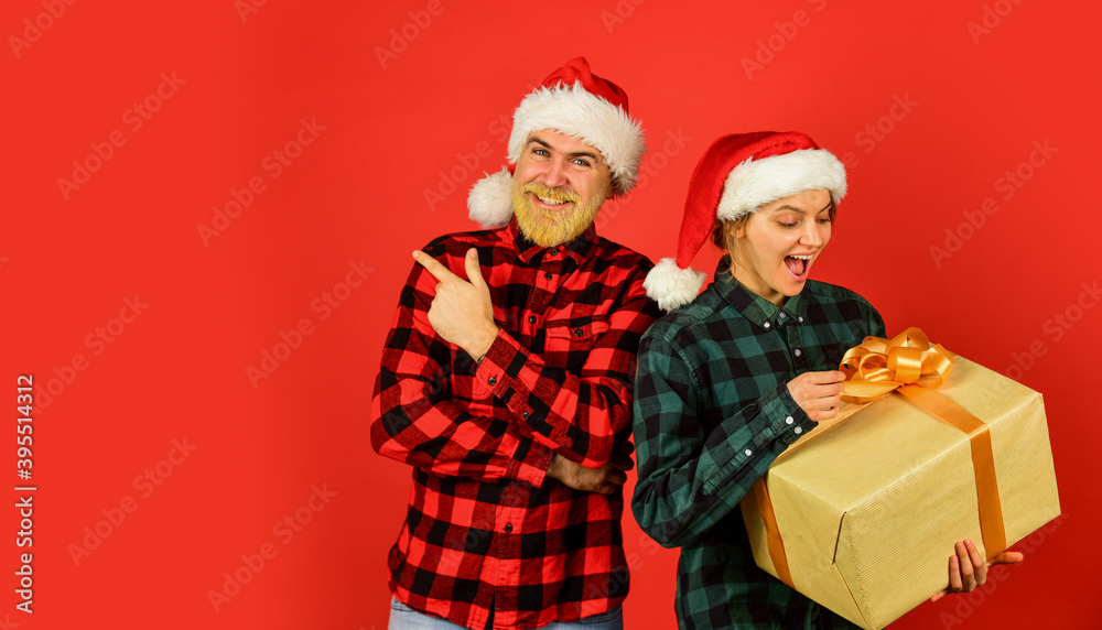 Fototapeta premium Giving present. Love and care. Man and woman christmas holiday celebration. Spread love. Gift for whole family. Family shopping. Surprise for spouse. Buy present. Christmas party. Christmas time