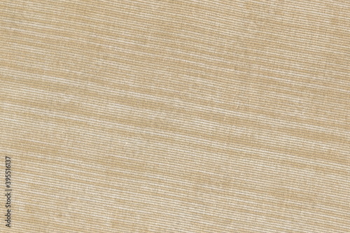 Texture of coarse natural linen fabric of natural warm color. Light brown burlap.