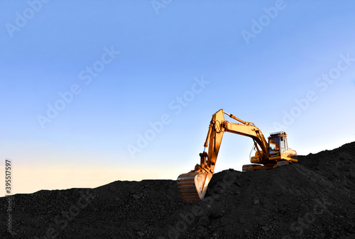 Wallpaper Mural Excavator during earthmoving at coal open pit on sunset background. Construction machinery and earthworks heavy equipment for excavation at quarry. Recyclin and coal mining industry Torontodigital.ca