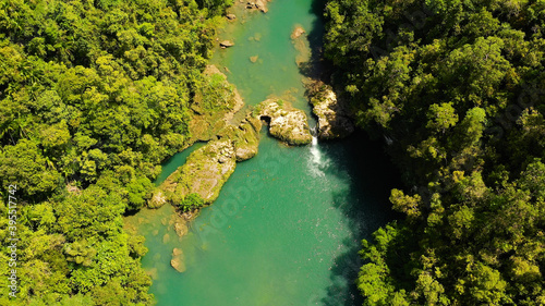 Aerial drone of Tropical Loboc river in the rainforest. Mountain river flows through green forest. Bohol, Philippines. © Alex Traveler
