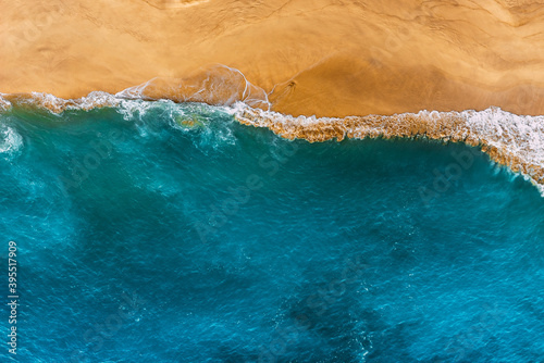 Beautiful sea landscape. Beautiful sandy beach with blue water. Wild beach with beautiful clear sea. Yellow sand with blue sea. Clean beach with clean sea. Ocean from a bird's eye view. Copy space