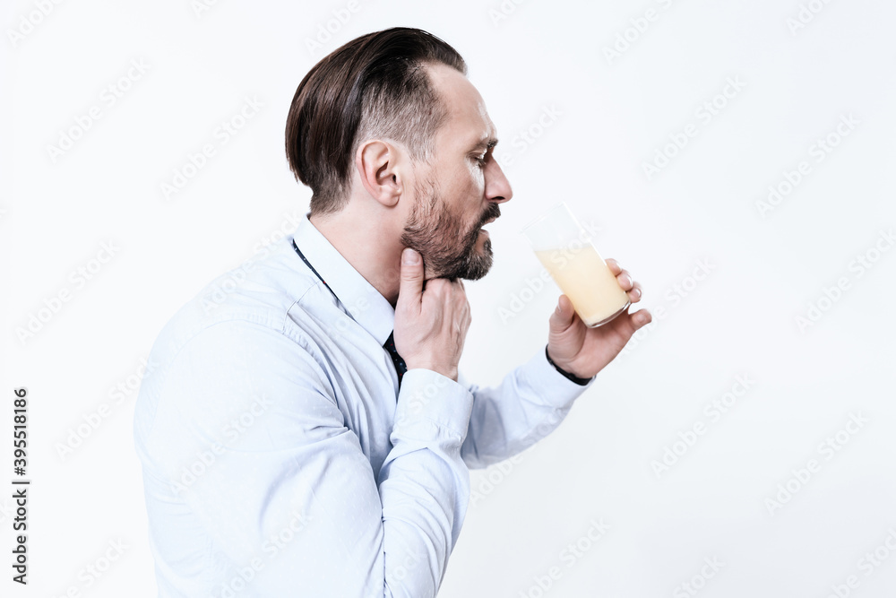 Man with medicine in his hand suffers from a sore. Man with medicine in his hand suffers from a sore.