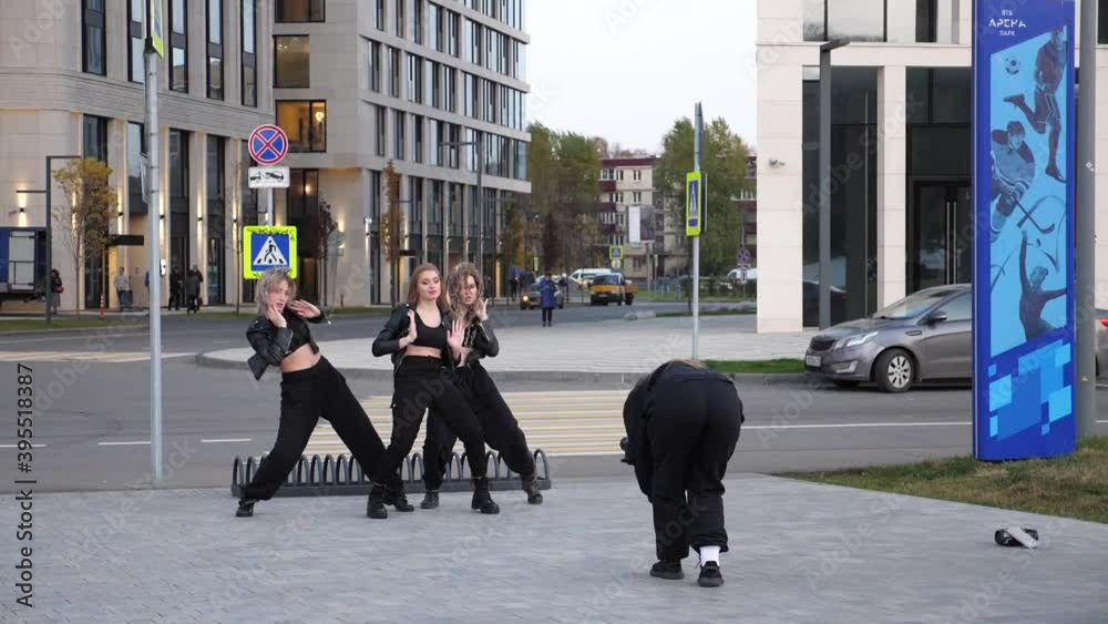 Group of female friends dancing together and blowing confetti. Group of women enjoying dancing outdoors. Group of female friends dancing together and blowing confetti. Group of women enjoying dancing outdoors.