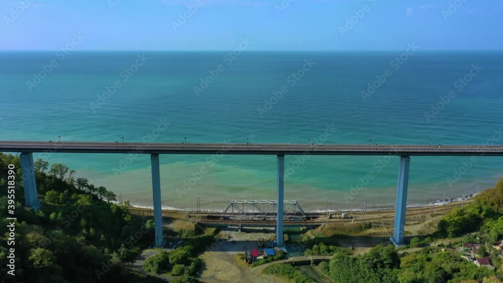 top side view to the cars driving on level highway on the sunny day. Picturesque aerial panorama of the road traffic and sun city. Sochi, Russia. top side view to the cars driving on level highway on the sunny day. Picturesque aerial panorama of the road traffic and sun city. Sochi, Russia.