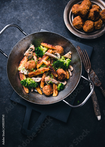 Vegan dumpling dish with bean balls, broccoli, mushrooms and cress