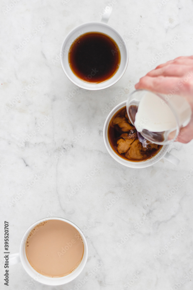 Three coffee cups with coffee and milk Three coffee cups with coffee and milk