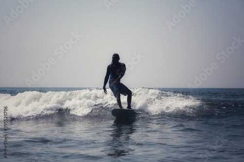 Surfers ride the waves. India