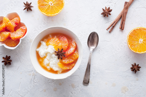 Rice porridge with blood oranges marinated in cinnamon and star anice photo