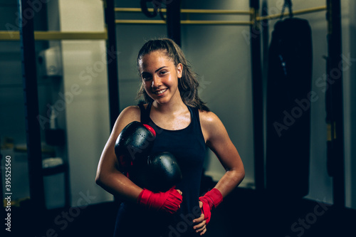 young woman posing with boxing gloves