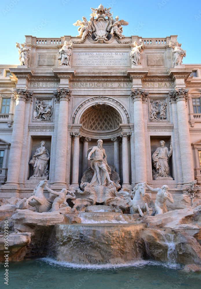 Fontana di Trevi at sunset with blue sky. Rome, Italy. 