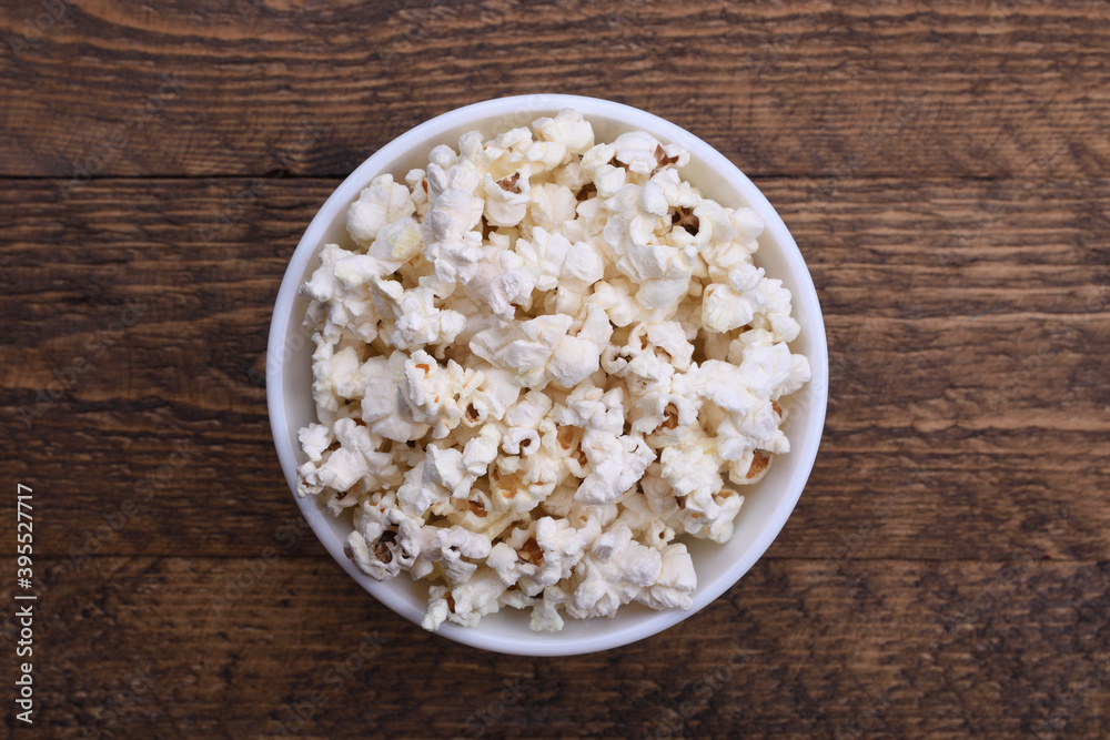 Popcorn in bowl on a red background. Close up. Top view Popcorn in bowl on a red background. Close up. Top view