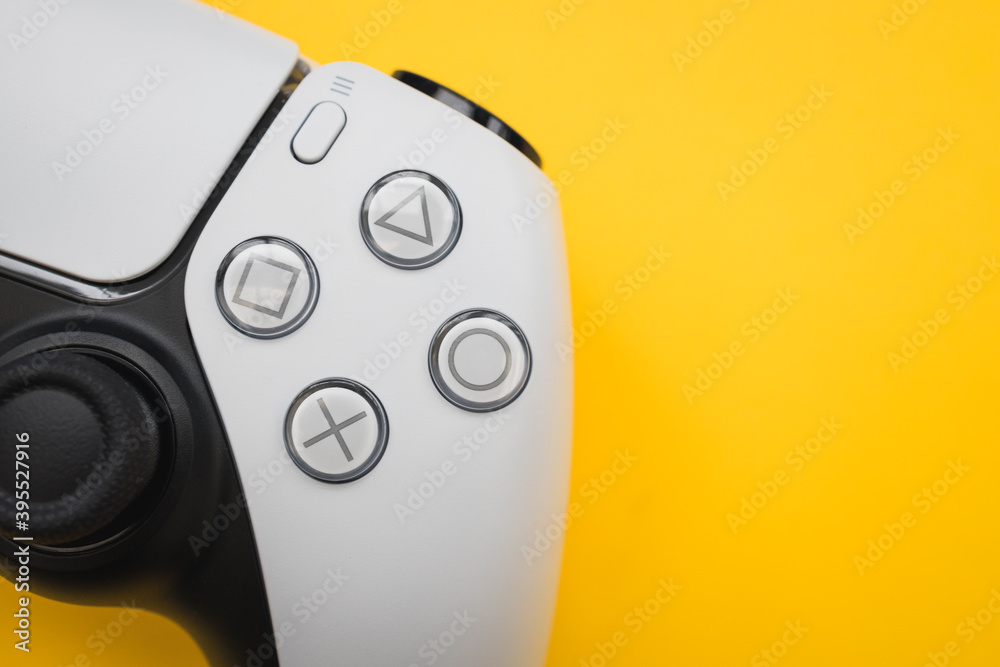 LONDON - NOVEMBER 24, 2020: PlayStation 5 video games PS5 controller yellow  color background Stock Photo | Adobe Stock