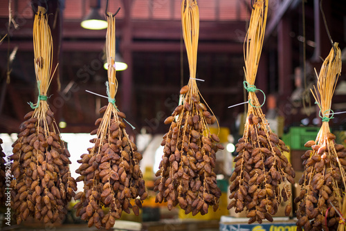 Suspended date bunches on a market