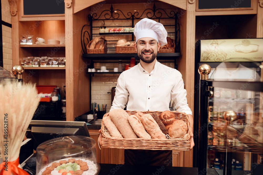 Young Bearded Man in Apron Standing in Bakery.
