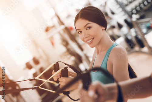 Girl swinging in the gym and looking at camera. photo