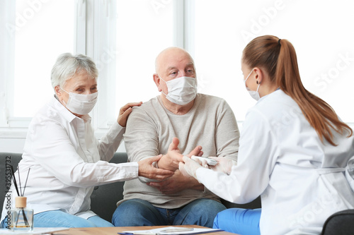 Doctor visiting senior diabetic couple at home