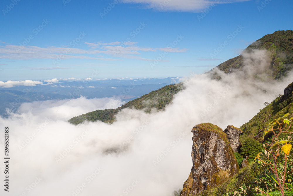 Beautiful scenic view of mountains and clouds against the sky in Kew Mae Pan nature trail at Doi Inthanon, Chiang Mai, Thailand. Famous tourist attractions of Thailand. Concept of holiday and travel